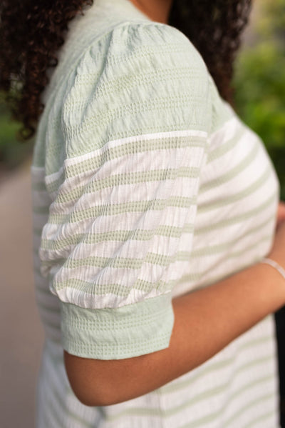 Close up of the sleeve on the sage stripe top