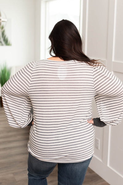 Back view of the plus size grey striped long sleeve top