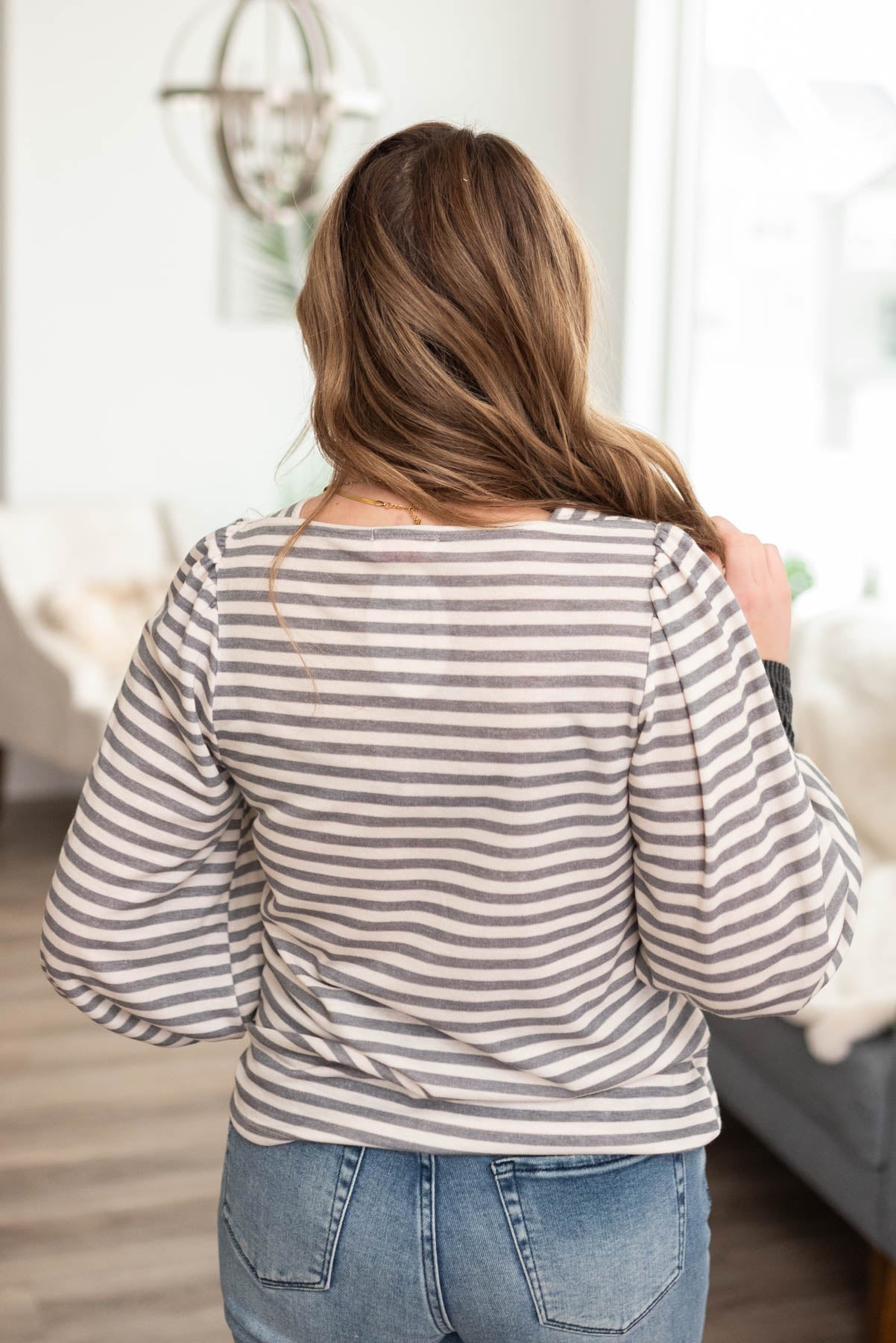 Back view of the grey striped long sleeve top