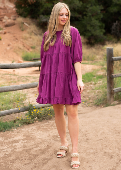 Knee length 3/4 sleeve berry dress with a tiered skirt and a ruffle at the hem