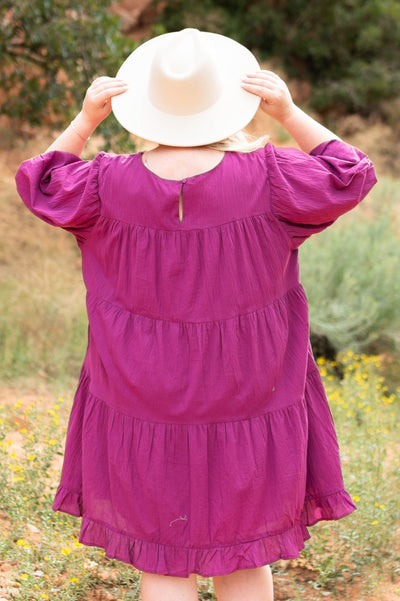 Back view of a plus size berry dress