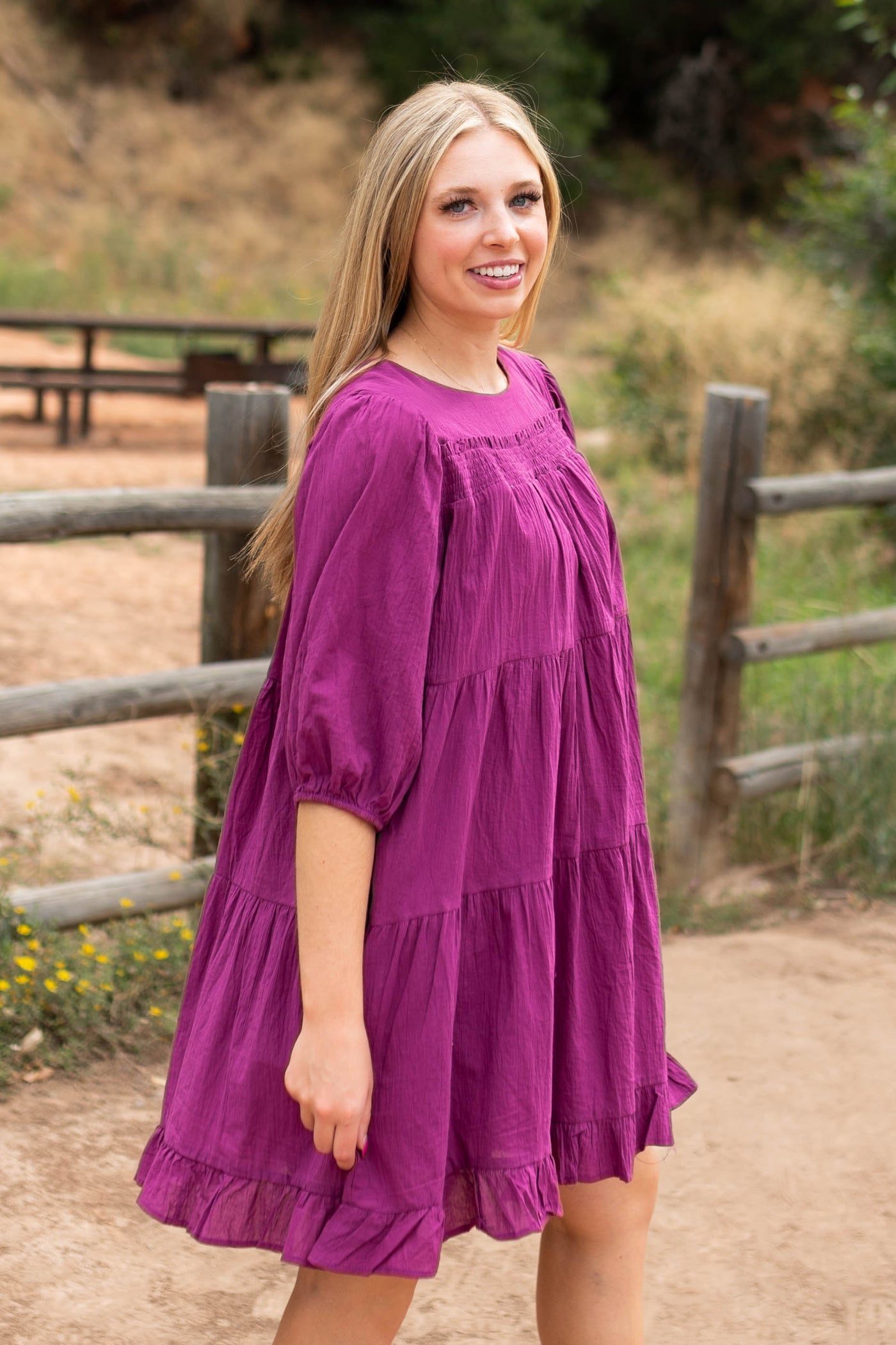 Side view of a knee length berry dress