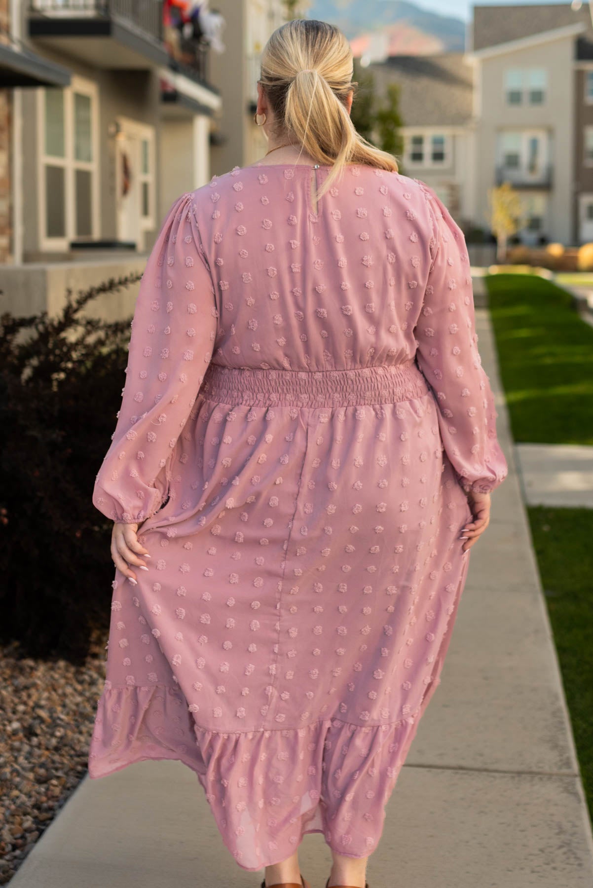 Back view of a plus size mauve dress