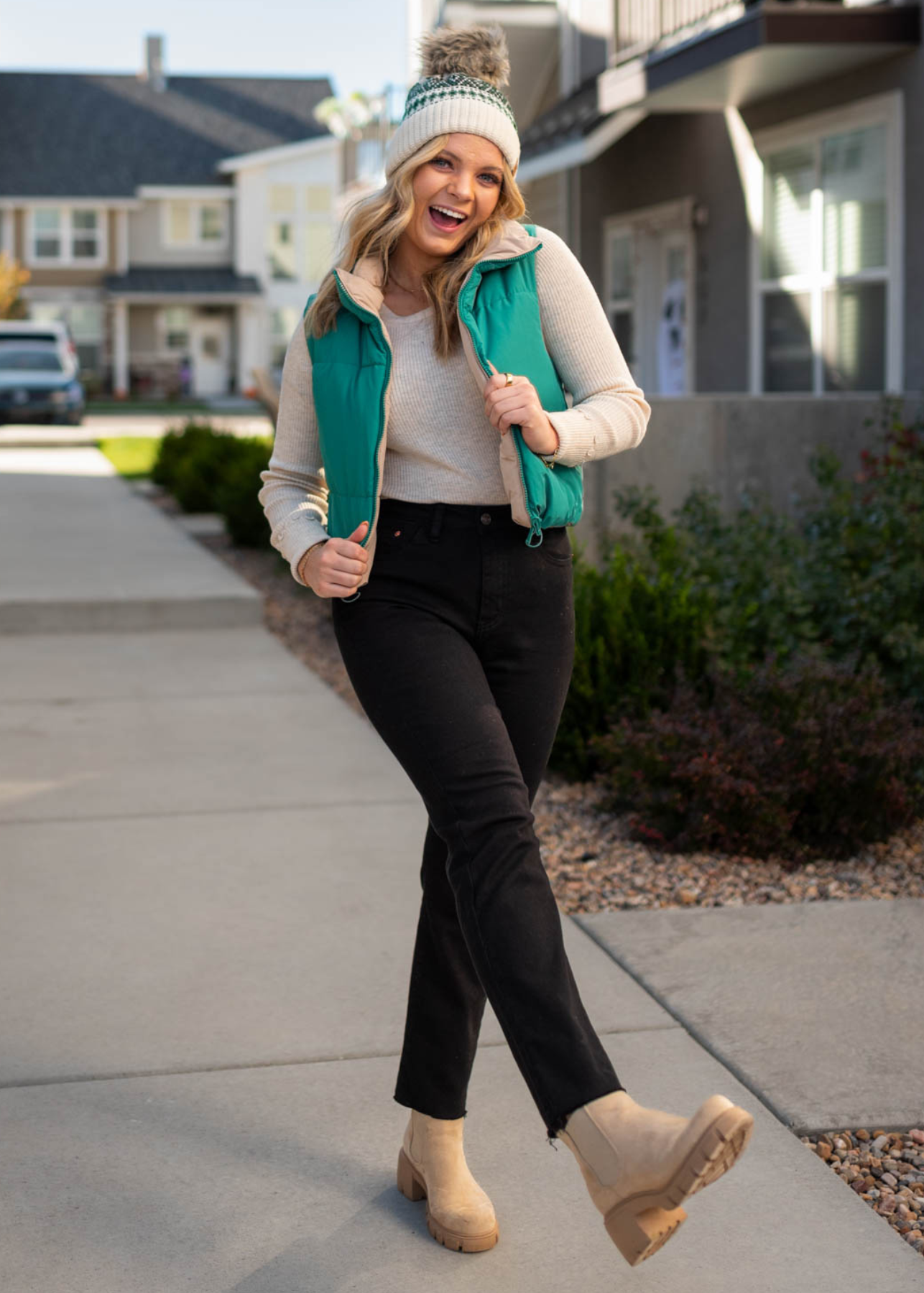Green reversible puff vest with tan on the inside
