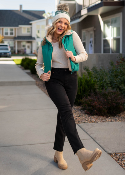 Green reversible puff vest with tan on the inside