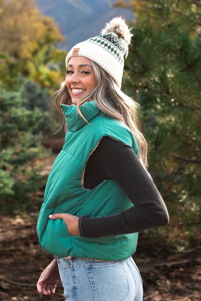 Side view of the green reversible puff vest
