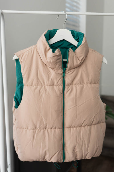 Taupe side of the green reversible puff vest