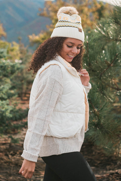 Side view of the ivory reversible puff vest