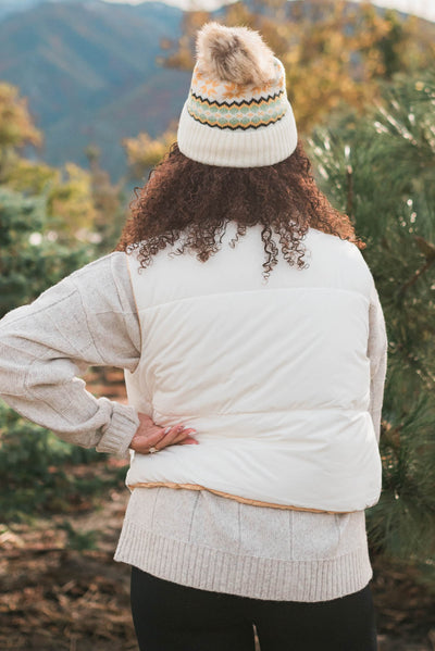 Back view of the ivory reversible puff vest