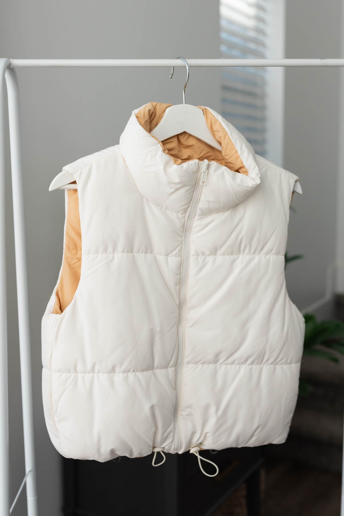 Ivory side of the ivory reversible puff vest