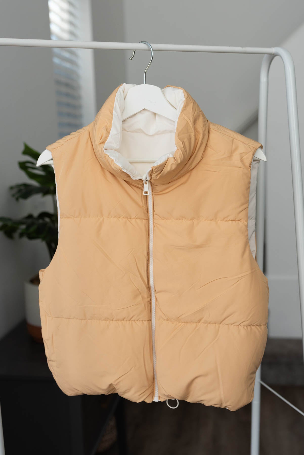 Tan side of the ivory reversible puff vest