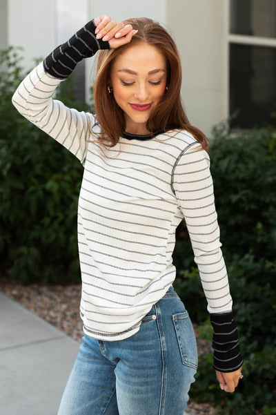 Side view of a long sleeve black striped top