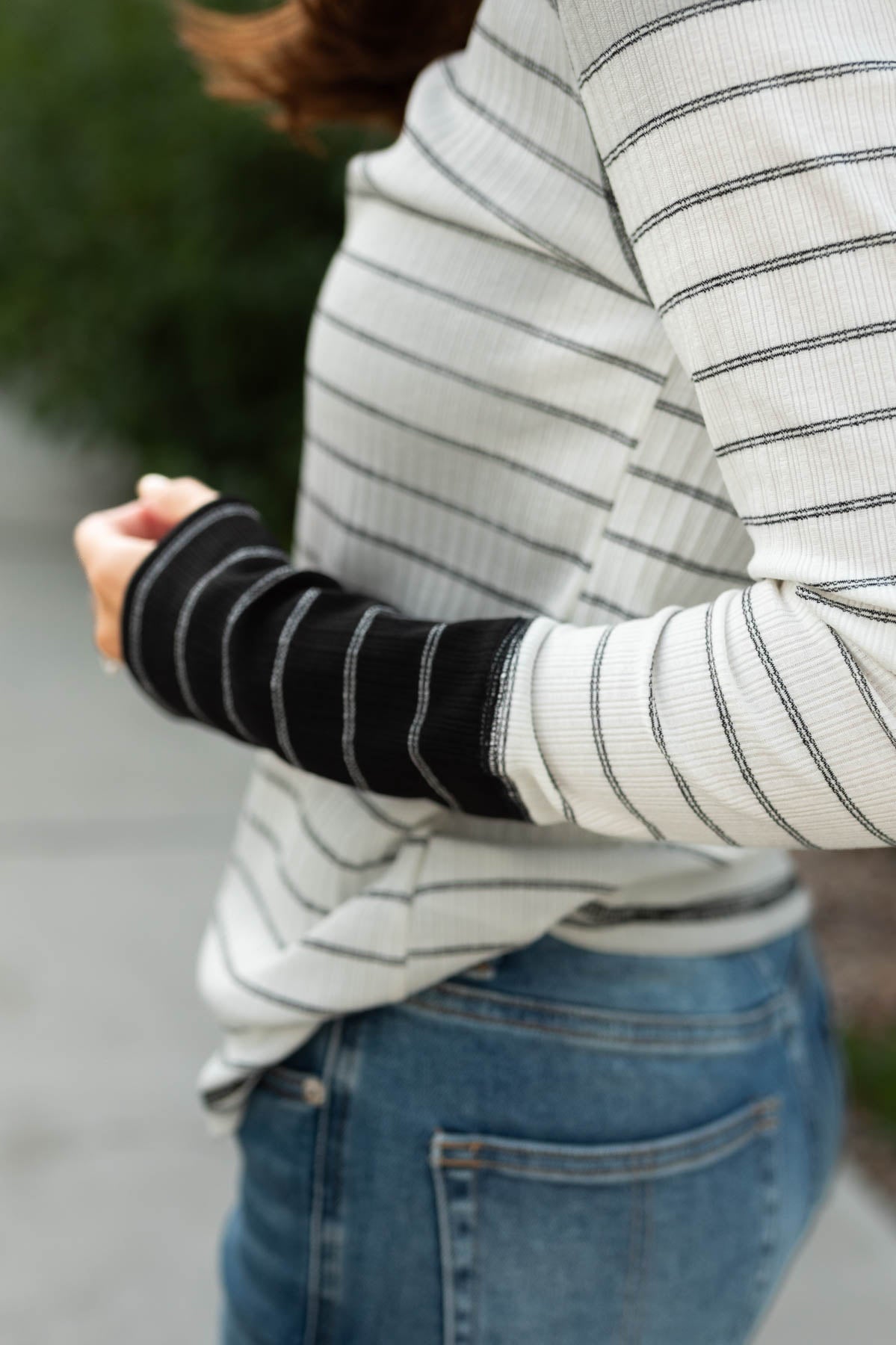 Sleeve of a black striped top