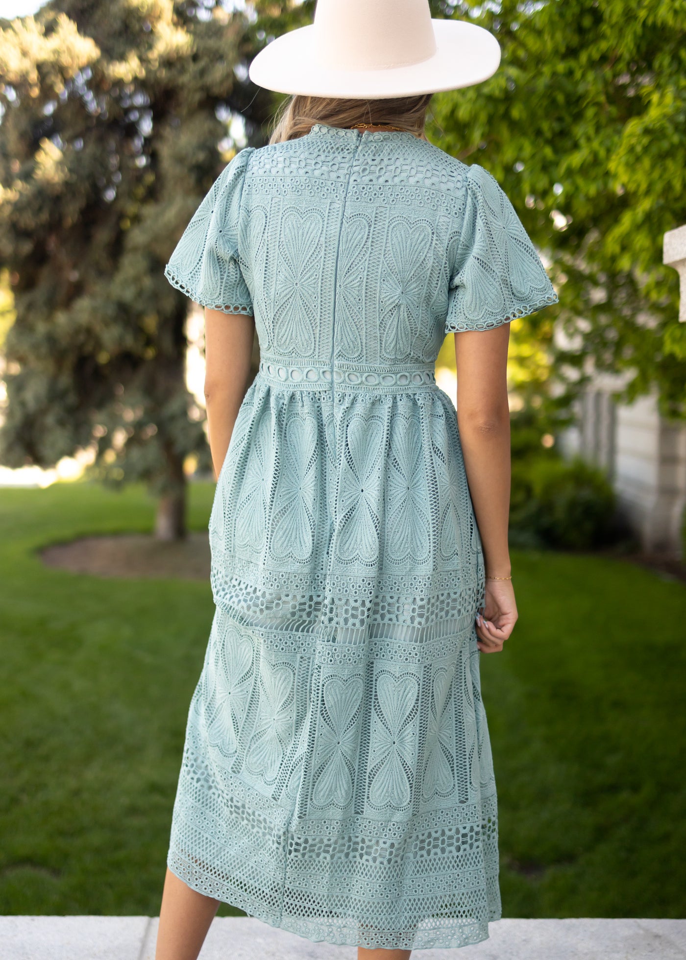 Back view of a dark seafoam dress that zips up the back