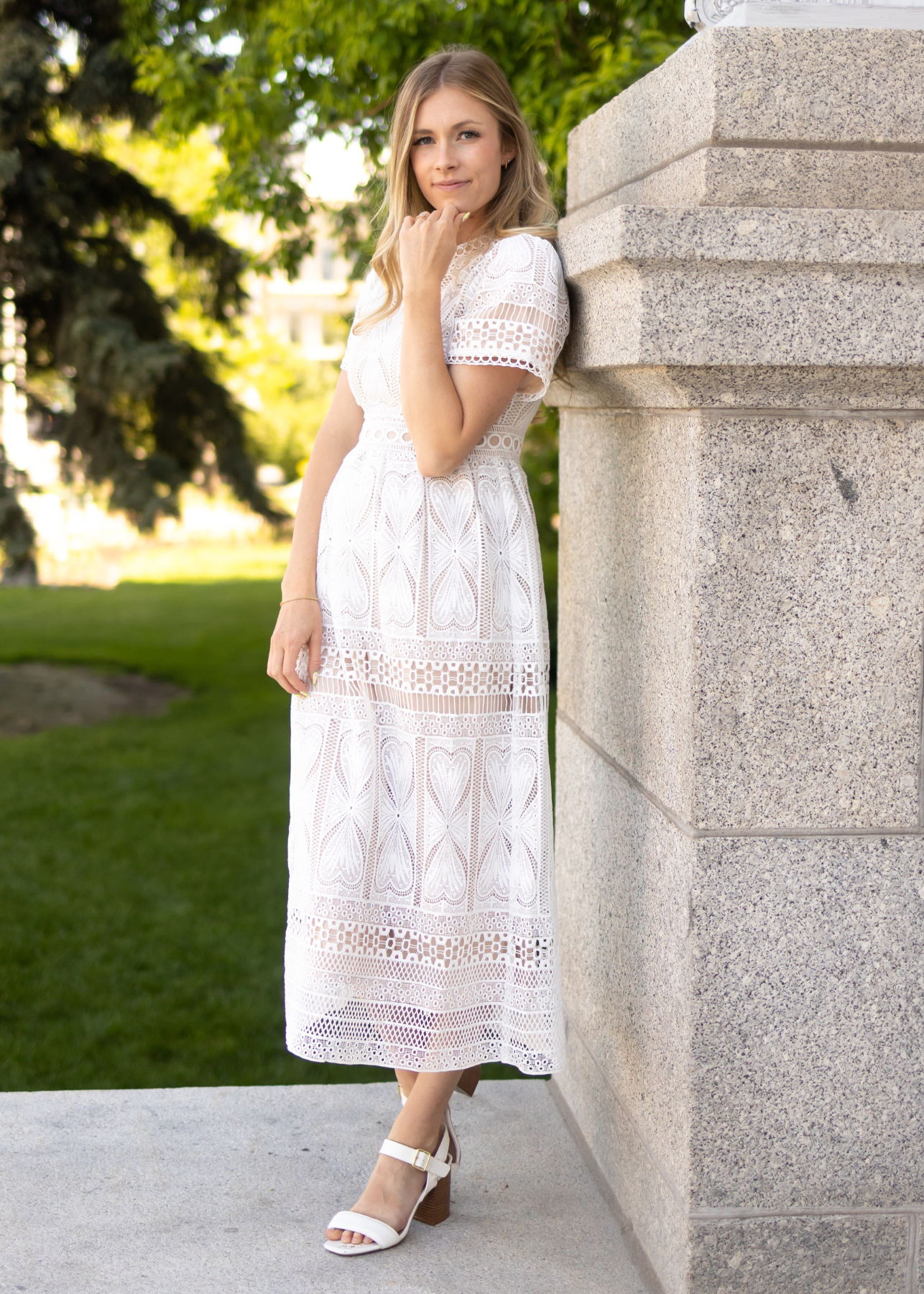 Side view of a short sleeve white lace dress