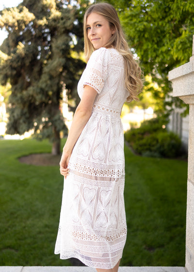 White lace dress with pleats on the skirt