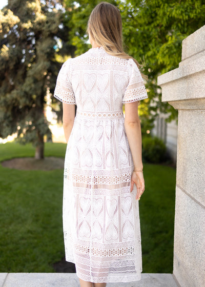 Back view of a short sleeve white lace dress