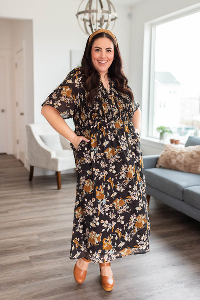 Short sleeve plus size black floral dress with pockets and smocked bodice