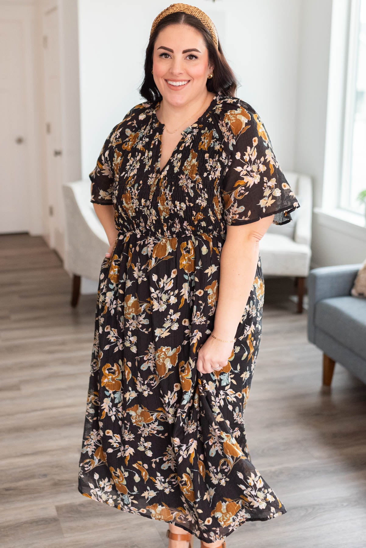 Plus size black floral dress with smocked bodice