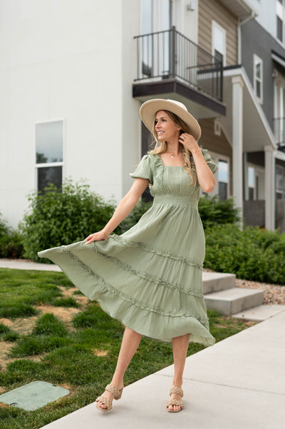 Short sleeve sage dress with square neck and tiered skirt