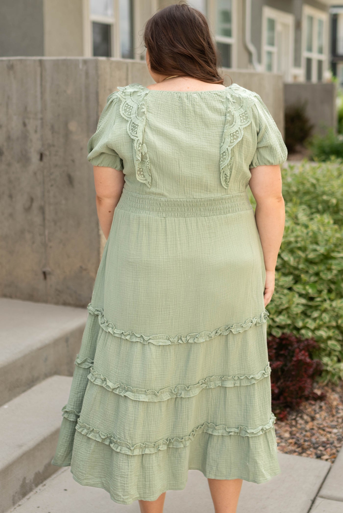 Back view of a plus size sage dress