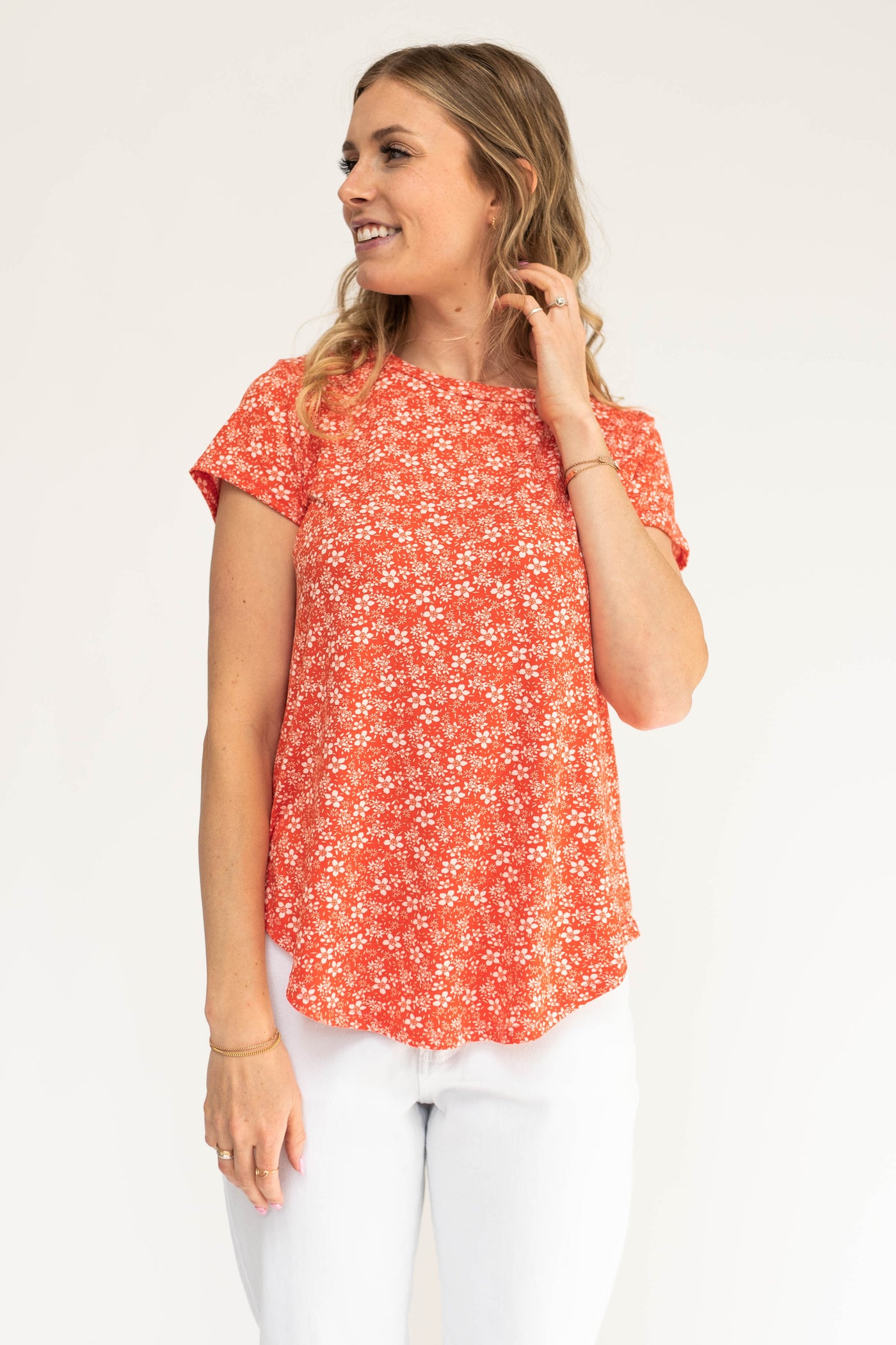 White floral print on a coral red top