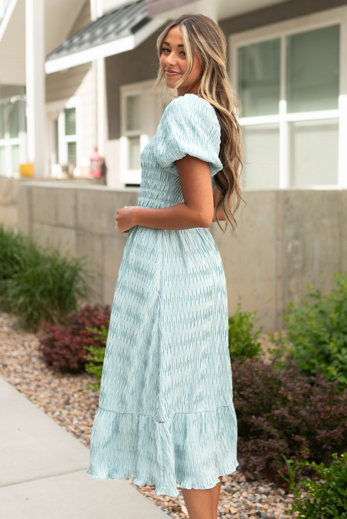 Side view seafoam dress with puff short sleeves and smocked bodice