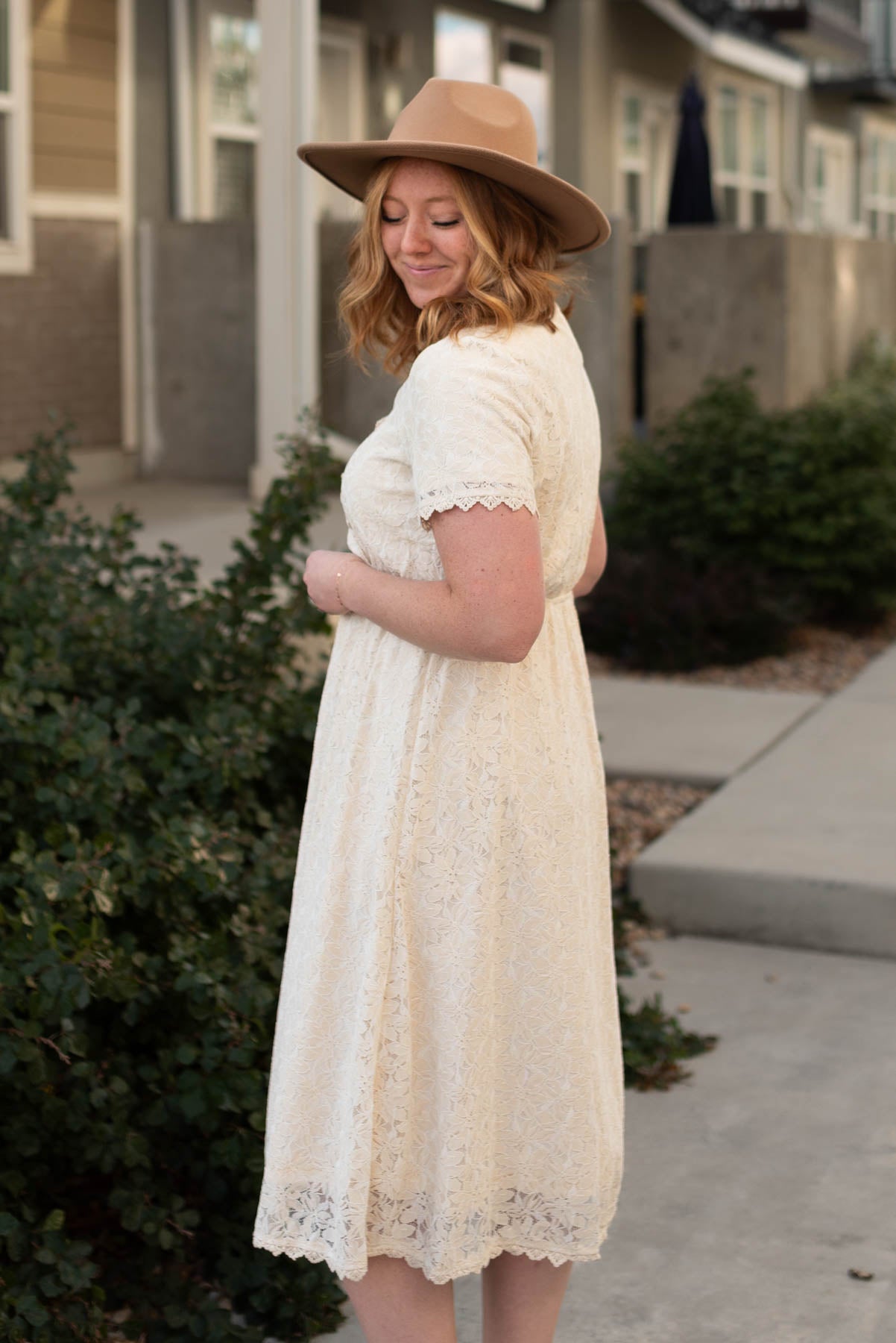 Side view of a cream lace dress