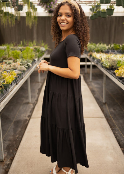 Side view of a black tiered dress