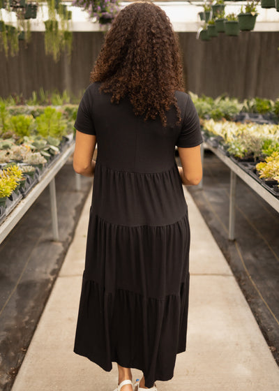 Back view of a plus size black tired dress