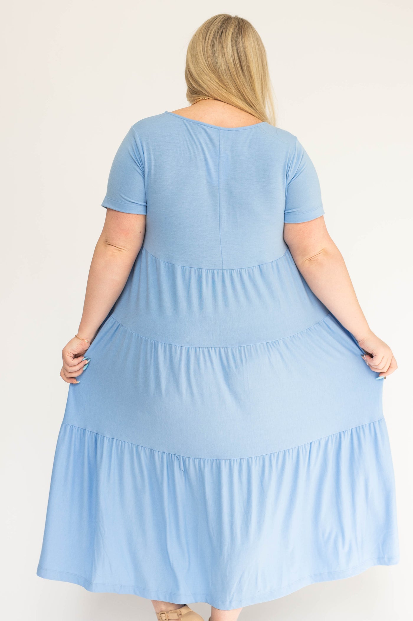 Back view of a plus size blue spring dress