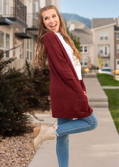 Side view of a burgundy cardigan