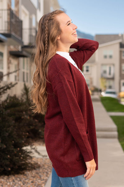 Side view of a burgundy cardigan