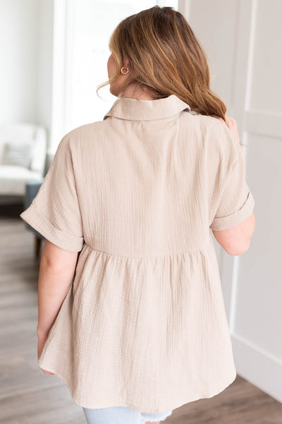 Back view of the taupe button down top