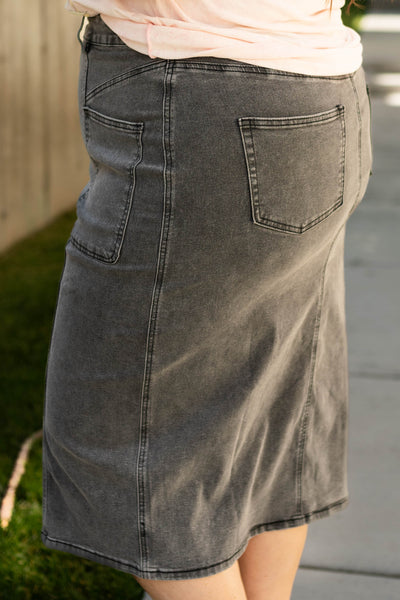 Side view of a plus size black skirt