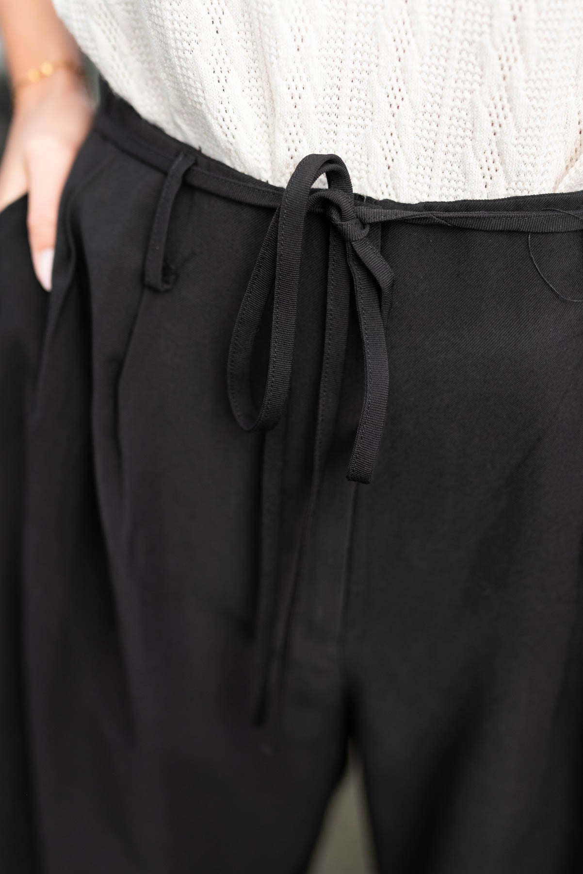 Black wide leg pants with pleats at the waist