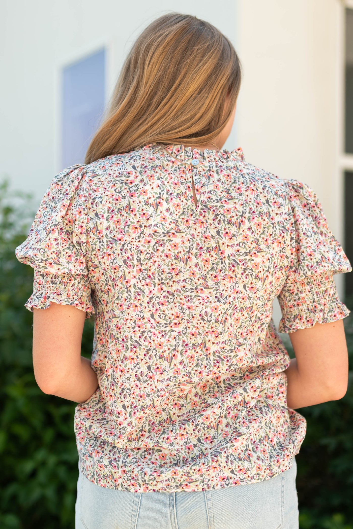Back view of a pink floral top