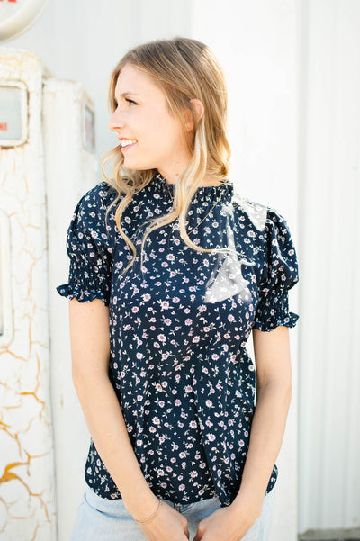 Short sleeve navy floral top with a high neck