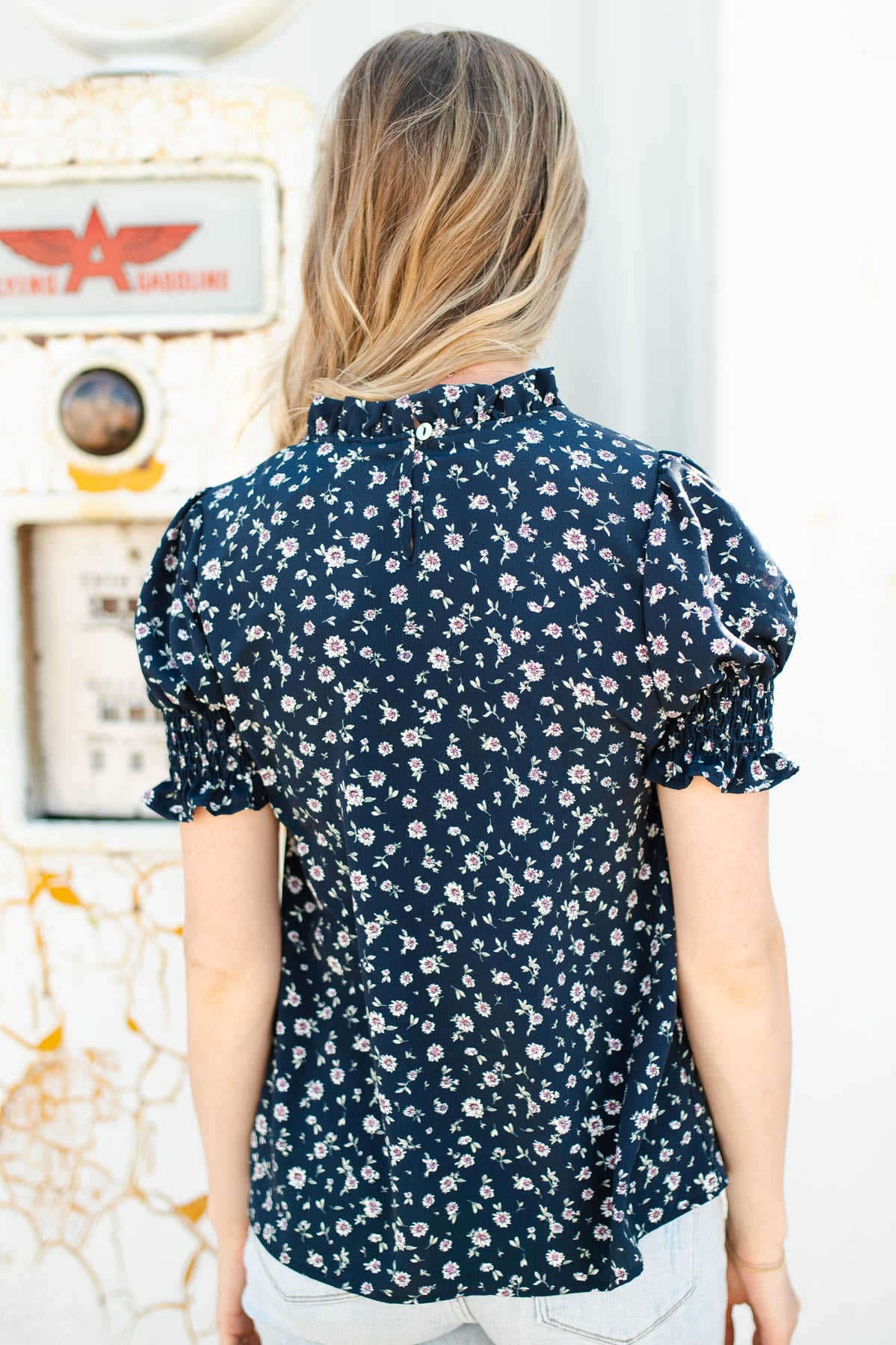 Back view of a navy floral top