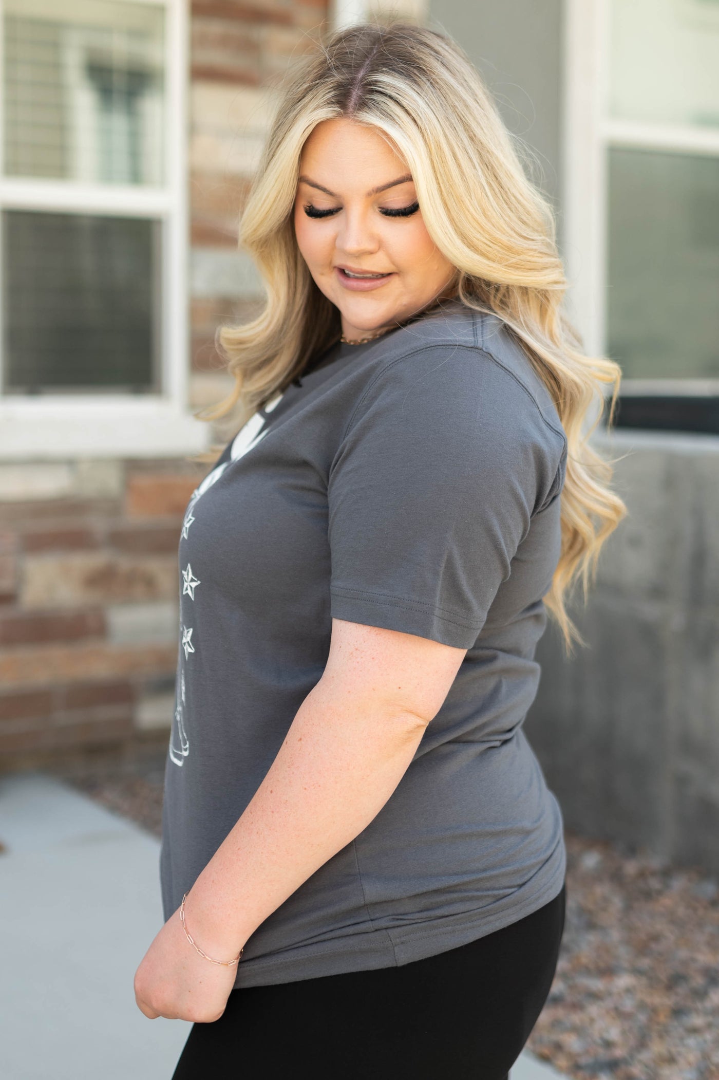 Side view of a plus size giddy up charcoal top