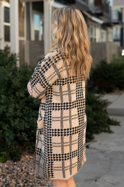 Side view of a taupe cardigan