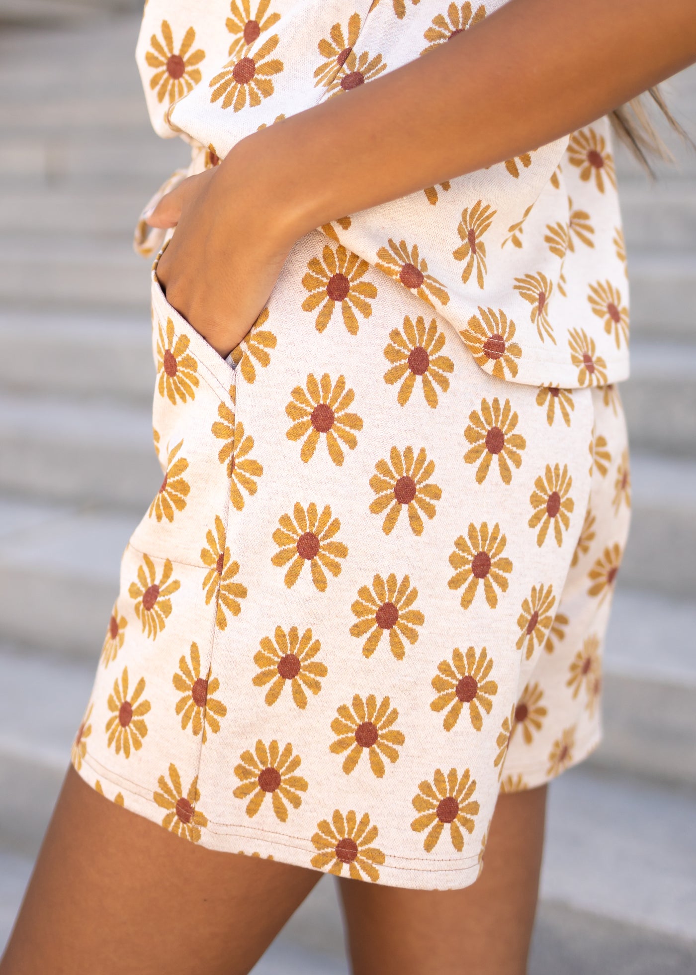 Side view of cream daisy shorts with pockets