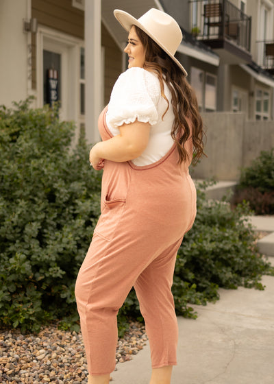 Side view of a plus size terracotta jumpsuit