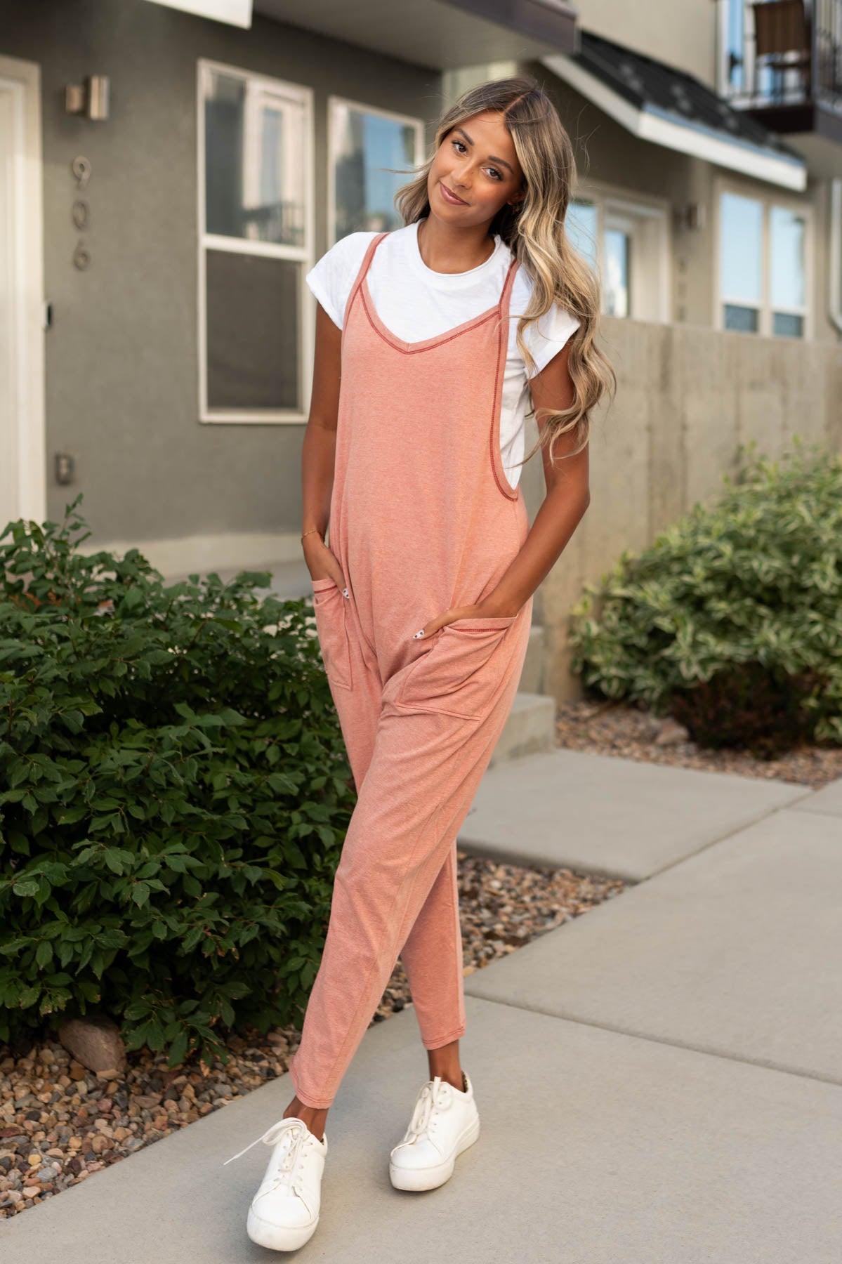Terracotta jumpsuit with wide v-neck and pockets