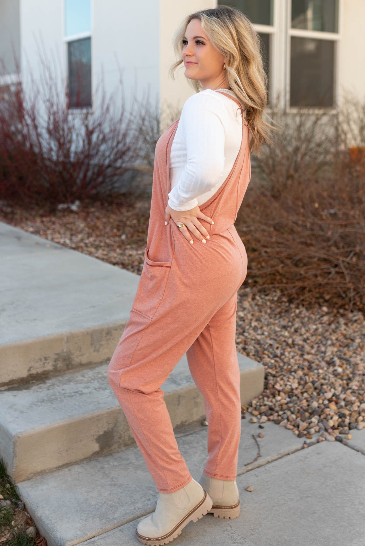 Side view of a terracotta jumpsuit