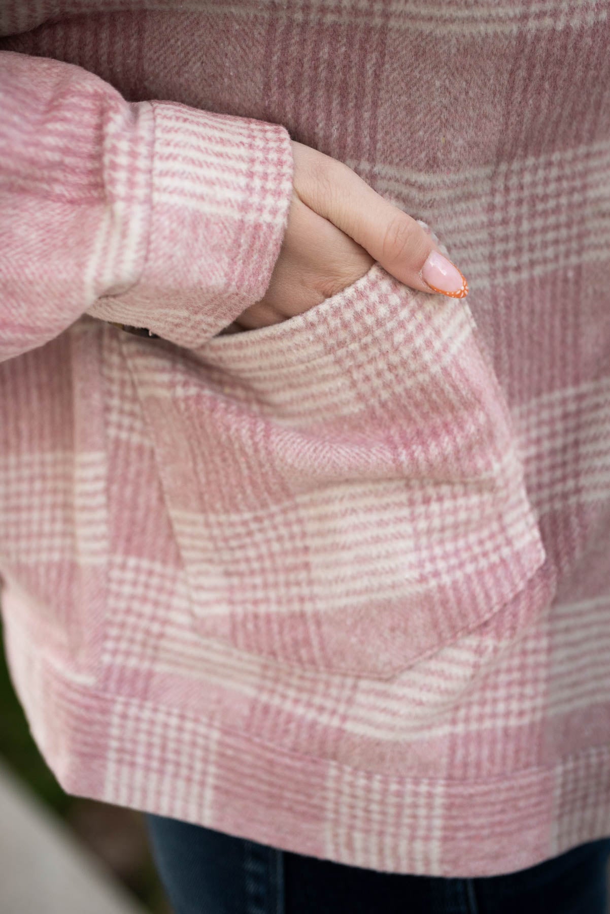 View of the fabric and pocket of the pink plaid shacket