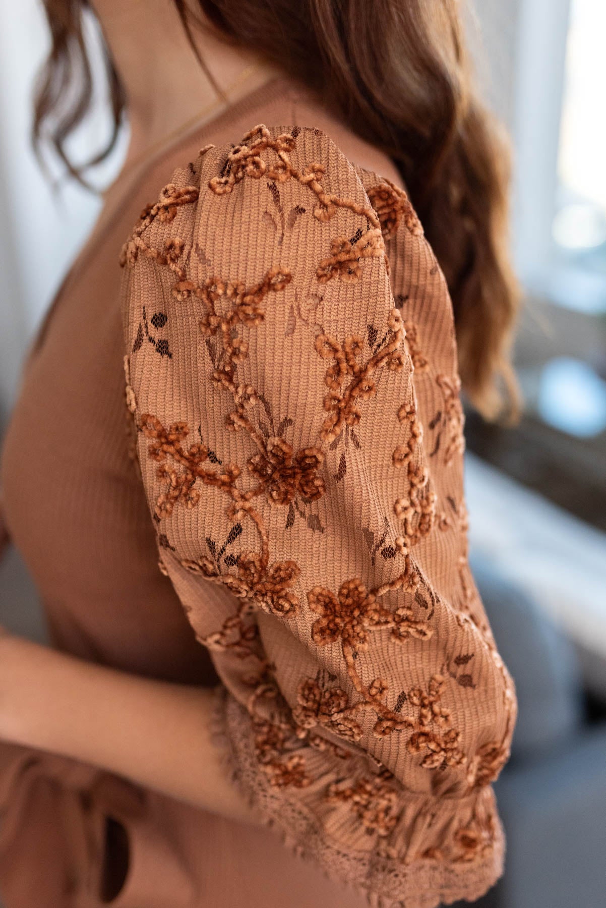 Brown dress with floral pattern on sleeves