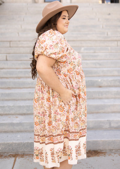 Side view of a plus size taupe dress