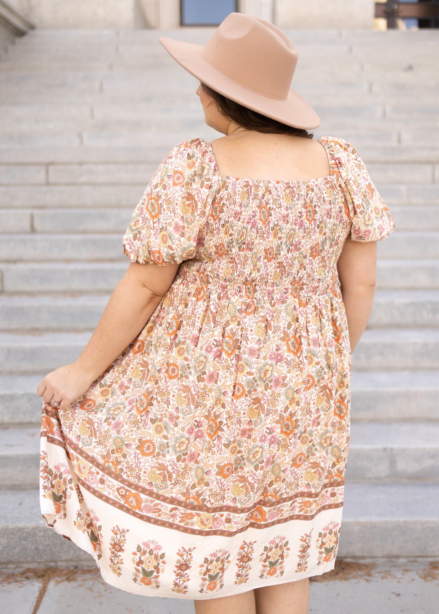 Back view of a plus size taupe dress