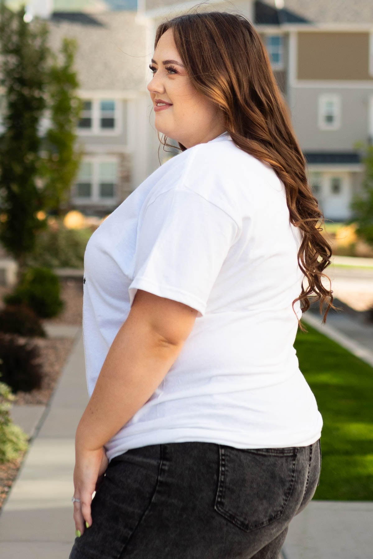 Side view of the plus size happy haunt white tee